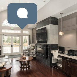 a lounge with tv fireplace and a chat bubble icon on top of the image