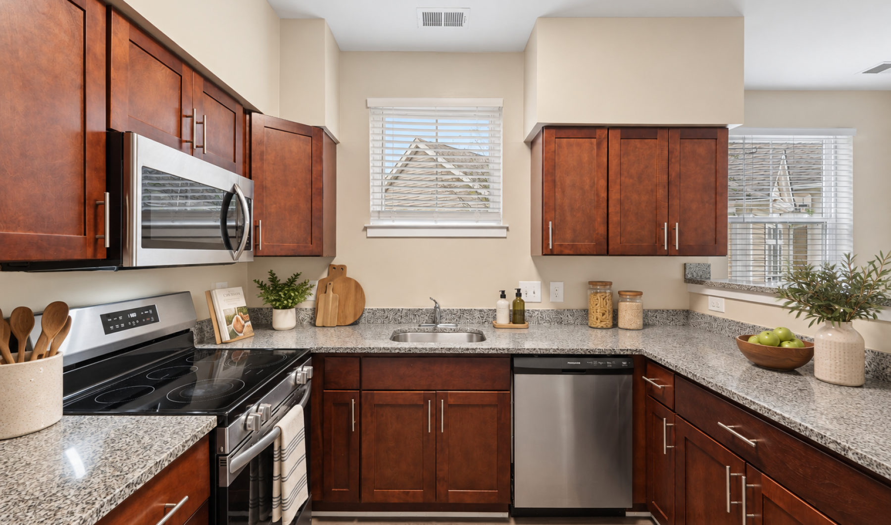 Brown kitchen with granite countertops and stainless steel appliances