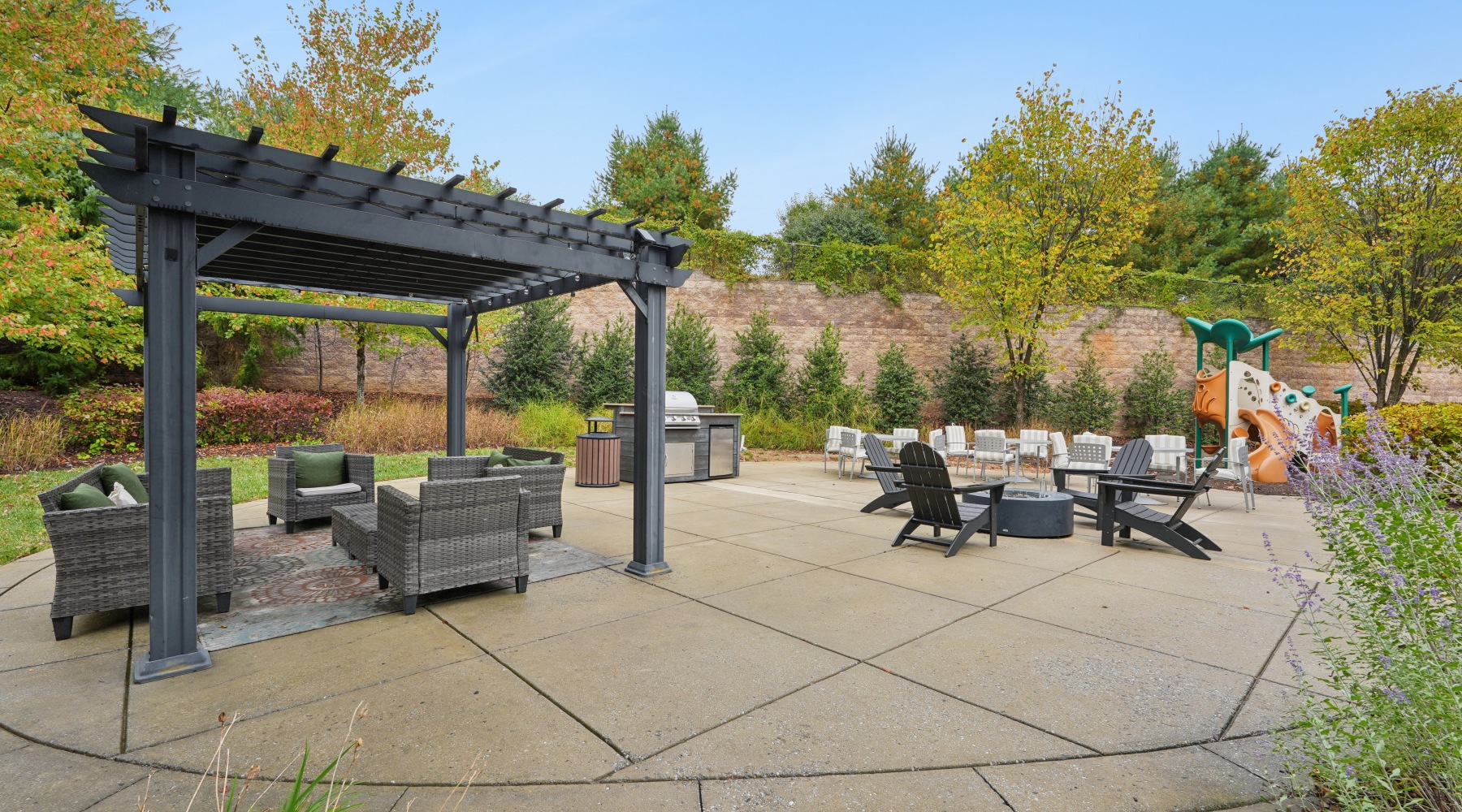 Large courtyard with several spaces for seating, grilling, and a playground